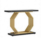 A modern console table featuring a rectangular black marble top with white veining, supported by a geometric hexagonal frame made of parallel gold-toned metal rods, resting on a matching black marble base.