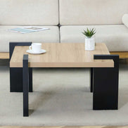 Compact MDF Coffee Table with modern black legs and wood finish top, styled with a cup and plant for accent table inspiration.