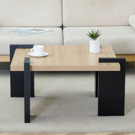 Compact MDF Coffee Table with modern black legs and wood finish top, styled with a cup and plant for accent table inspiration.