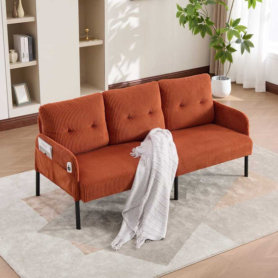 Orange sofa with a white blanket in a living room setting