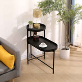 Black side table with decorative items in a living room setting