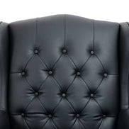 Black leather armchair with tufted backrest on a white background