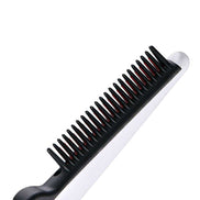 Close-up of electric straightening hair comb with black and red teeth
