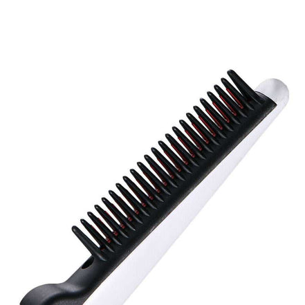 Close-up of electric straightening hair comb with black and red teeth