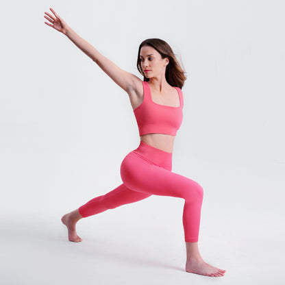 Woman in warrior yoga pose wearing pink Seamless Tummy Control Yoga Pants, demonstrating stretch and comfort for workouts.