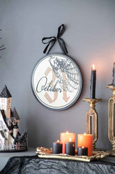 Halloween circle sign hanging with black ribbon, featuring October 31 date and spider web, ideal for festive home decoration