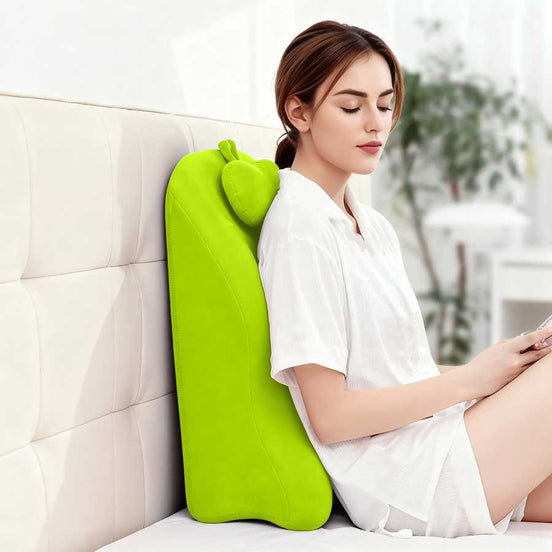 Woman using Ergonomic Spinal Posture Support Pillow - Memory Foam vertically on a sofa for improved lumbar posture and back comfort.