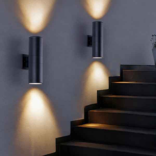 Modern black wall lights on a gray wall with steps below