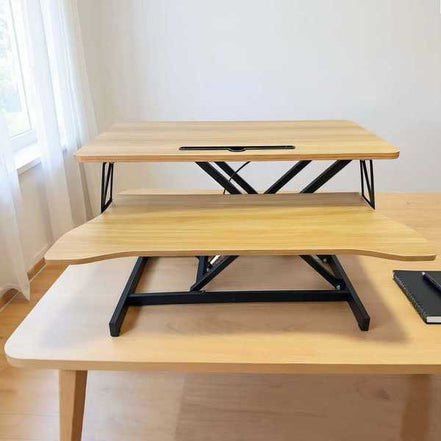 Compact 32 inch desk converter placed on a wooden desk, showcasing its ergonomic dual-tier design for comfortable computing.
