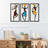 Bohemian Macrame Wall Hanging with African dancer design displayed above a wooden console with books, candles, and plants. Handmade decor in vibrant colors.