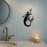 Mermaid Sea King Iron Relief Art beside round mirror and candle on bathroom wall, a unique handcrafted coastal wall sculpture.