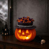 A Halloween-themed candy display featuring a carved orange jack-o&