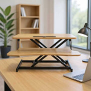 Modern office setup featuring 32 inch height adjustable desk converter with dual-tier platform for dual monitors or laptop use.
