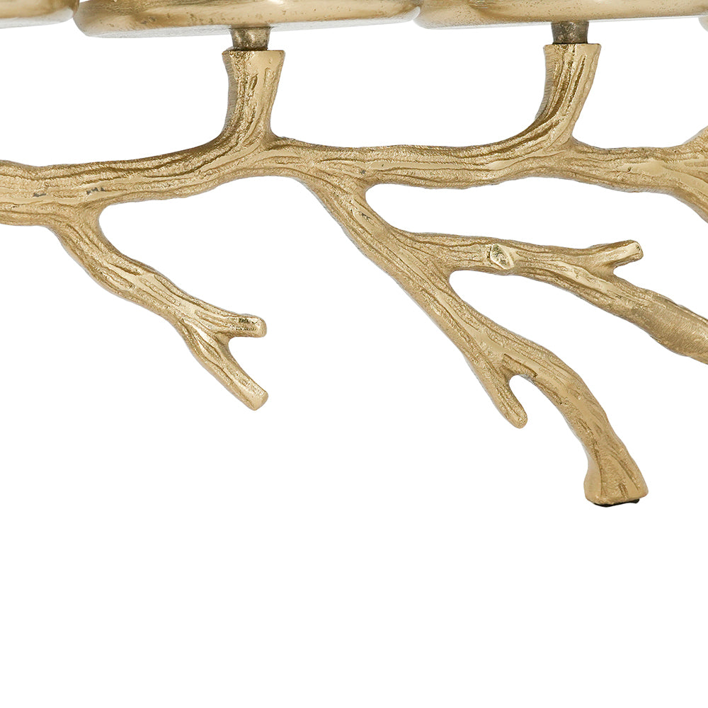 A close-up of a branch-shaped decorative object with a textured metallic finish, shown against a plain white background.