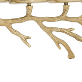 A close-up of a branch-shaped decorative object with a textured metallic finish, shown against a plain white background.