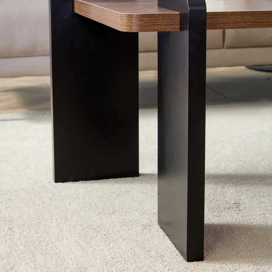 Close-up of black leg and walnut top on the MDF Coffee Table, showcasing durable build and modern design for minimalist furniture collections.