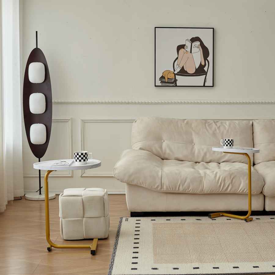 Modern living room with beige sofa, side table, and decorative elements.