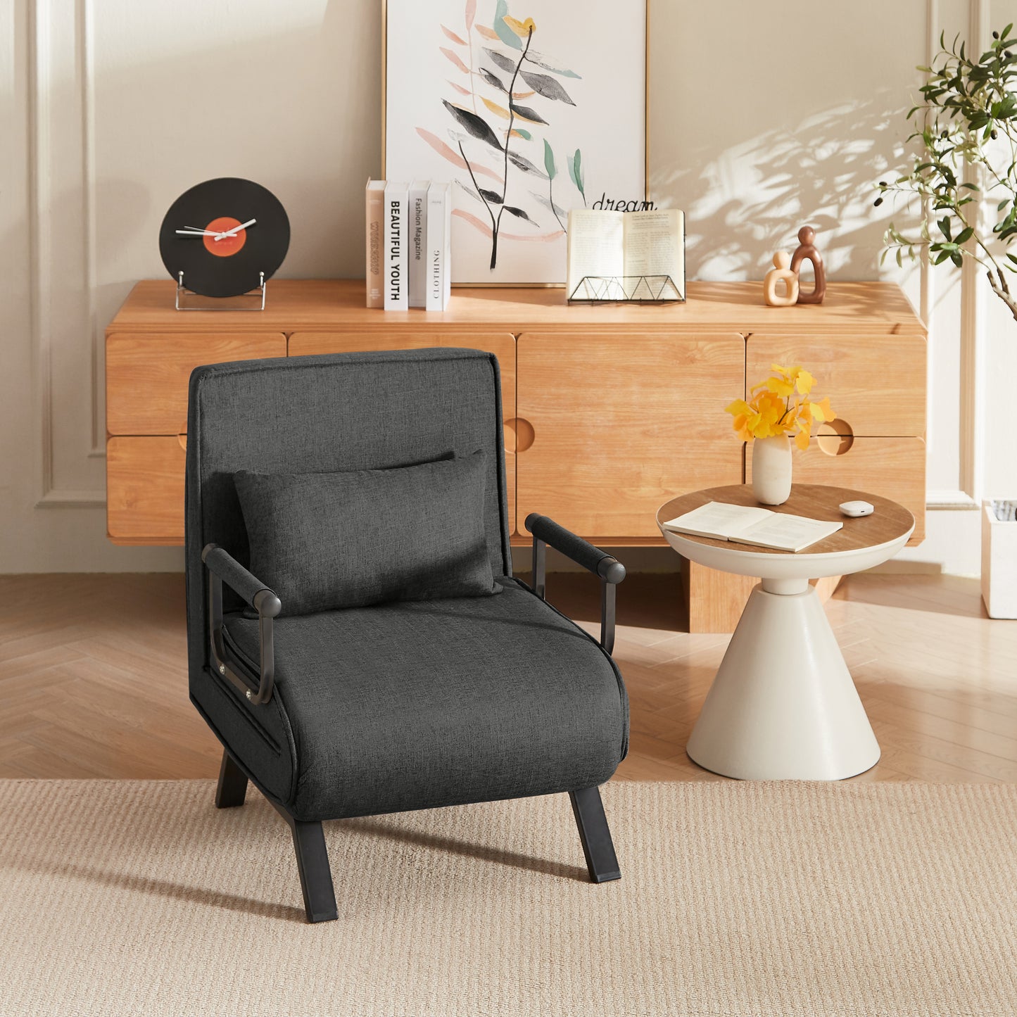 Black Folding Chair Bed in upright position with cushion, styled in a cozy modern room for multifunctional seating.