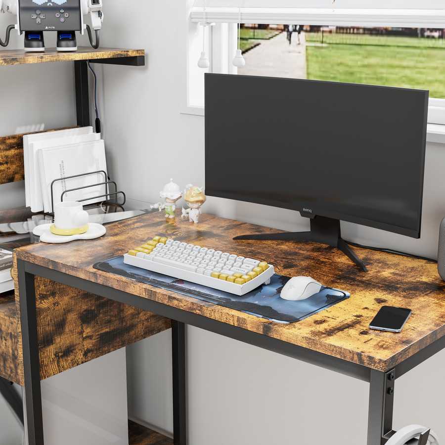 Desktop surface of computer desk with monitor, keyboard, and mouse, emphasizing spacious work area and rustic wood texture.