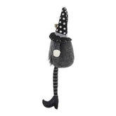 Back view of a black gnome Halloween ornament showcasing a tall polka dot hat, long striped legs, and plush body, ideal for seasonal decor.