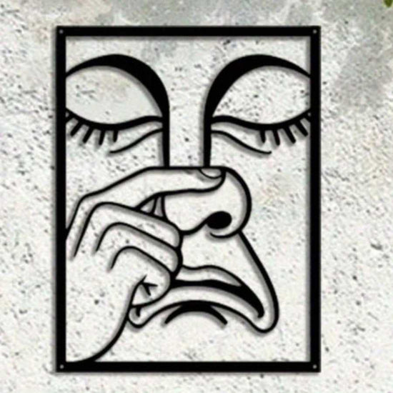 Funny Nose Picking Expression Wall Art in black iron on concrete wall, perfect for quirky home decor or game room accent.