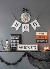 Halloween circle sign set of 2 with October 31 date, black spider web design, hanging on gray wall for seasonal home decor