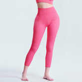 Front view of pink Seamless Tummy Control Yoga Pants showing high waist and ankle-length fit for women’s activewear.