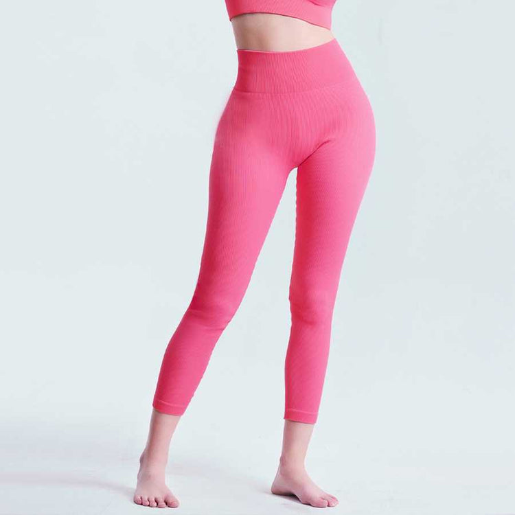 Front view of pink Seamless Tummy Control Yoga Pants showing high waist and ankle-length fit for women’s activewear.