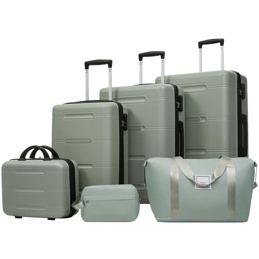 Set of green suitcases and travel bags on a white background
