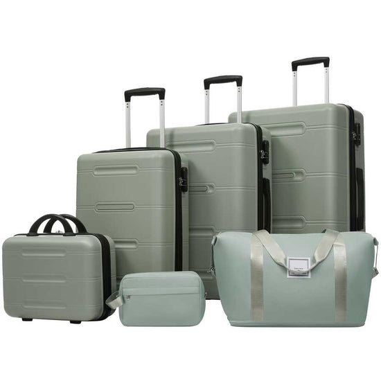 Set of green suitcases and travel bags on a white background