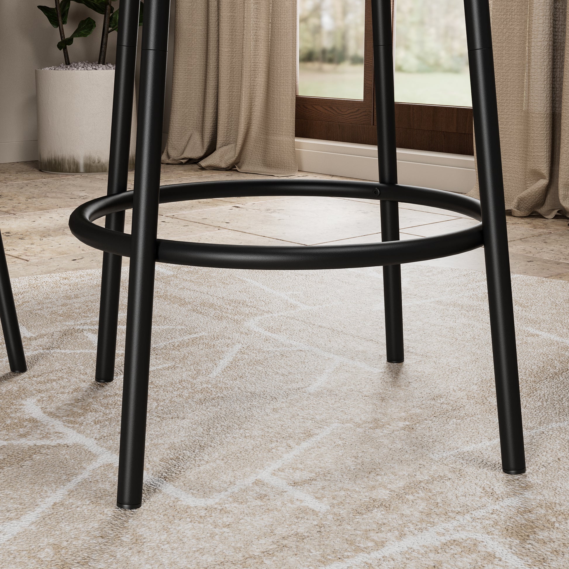 Detail view of the black metal footrest and legs from the 3-Piece Bar Table Set with 2 Stools, emphasizing its sturdy build and modern style.