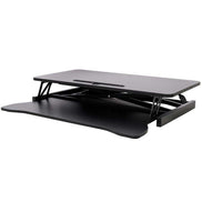 Adjustable laptop desk in fully lowered position with keyboard tray tucked in, ideal for compact office environments.