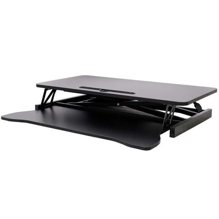 Adjustable laptop desk in fully lowered position with keyboard tray tucked in, ideal for compact office environments.