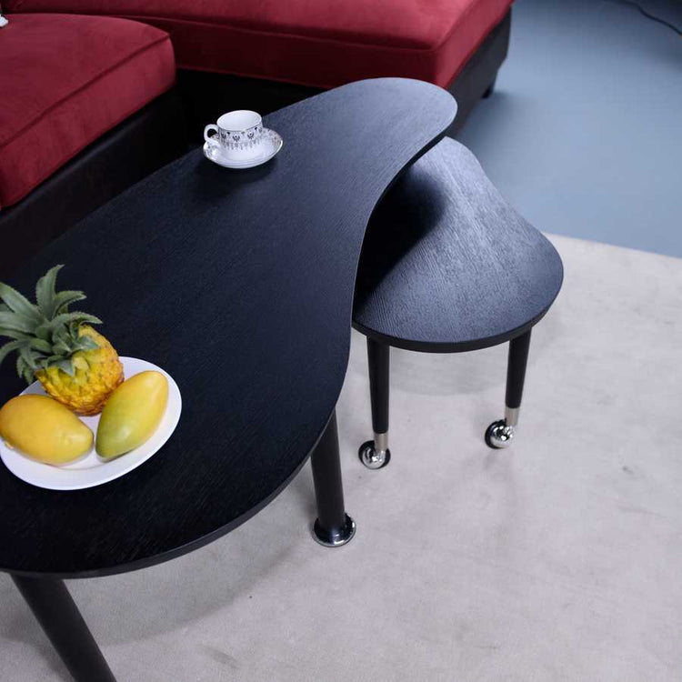 Compact 360 Rotatable Coffee Table with tea set and fruit, emphasizing its stylish kidney shape and space-saving storage.