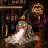 Halloween witch decor with glowing green eyes, wide open mouth, long gray hair, black pointed hat with skull, spooky indoor setting