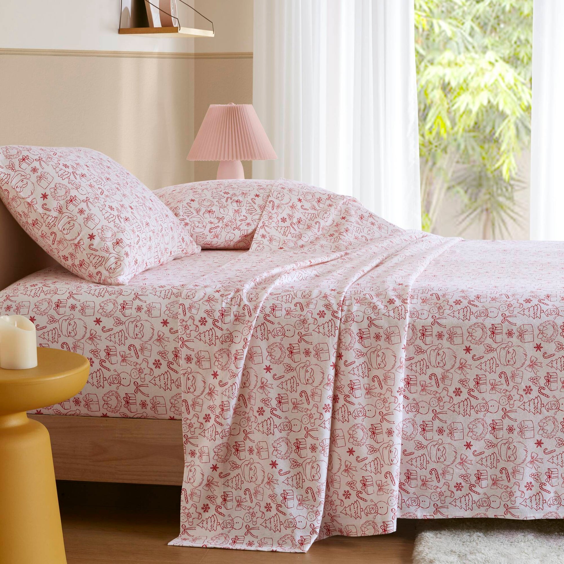 Twin XL Cotton Flannel Sheet Set in Holiday Doodles print displayed on a bed, ideal for festive dorm room bedding and winter comfort.