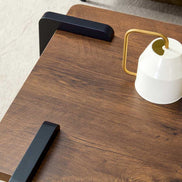 Detail of walnut MDF tabletop with black leg accents, highlighting the smooth finish and minimalist aesthetic of this modern coffee table.