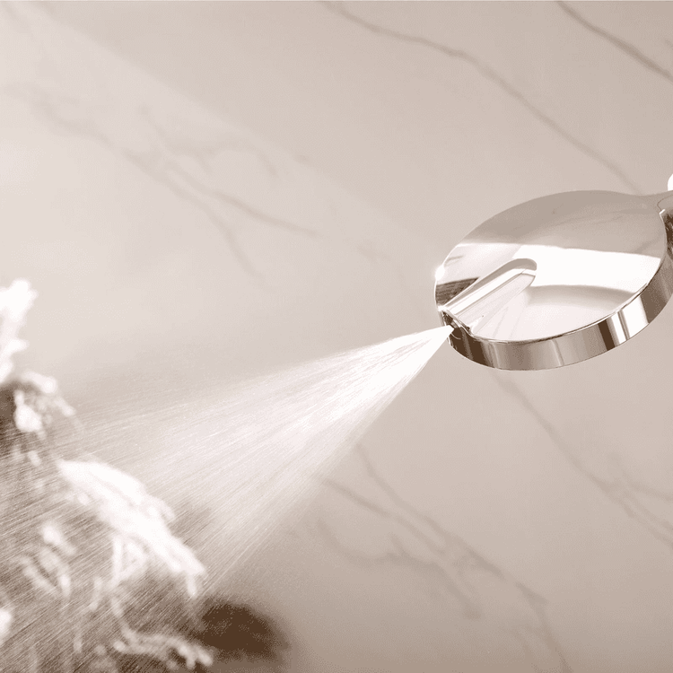 Shower head with water spray on a neutral background