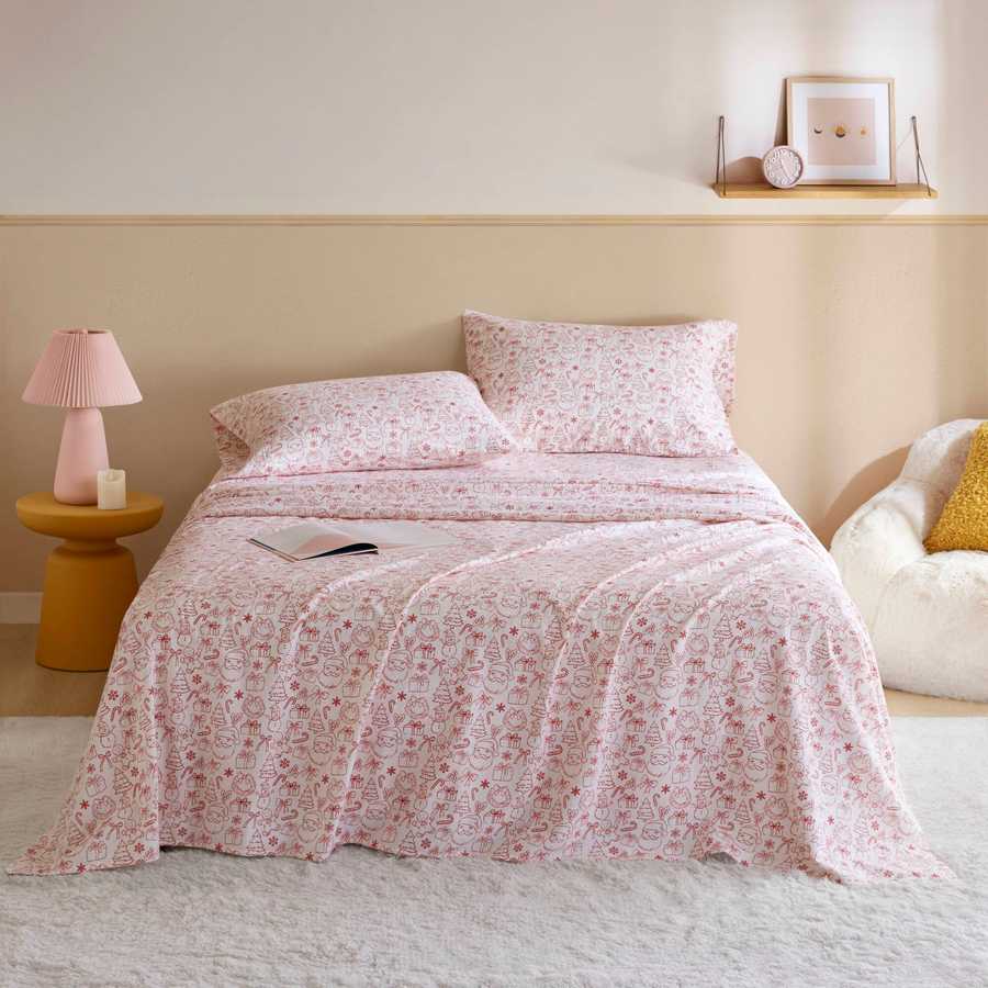 Holiday Doodles - Twin XL Cotton Flannel Sheet Set on a neatly made bed with festive red holiday prints, ideal for cozy dorm room decor.