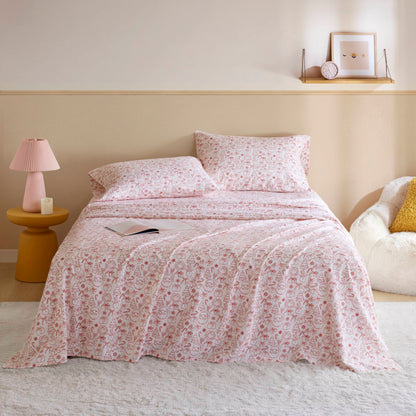 Holiday Doodles - Twin XL Cotton Flannel Sheet Set on a neatly made bed with festive red holiday prints, ideal for cozy dorm room decor.