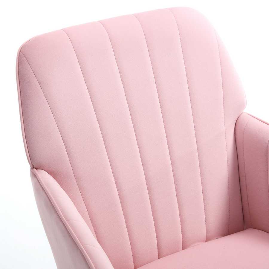 Close-up of a pink upholstered chair with a quilted pattern.