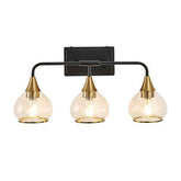 Three-light wall sconce with gold fixtures and clear glass shades on a white background