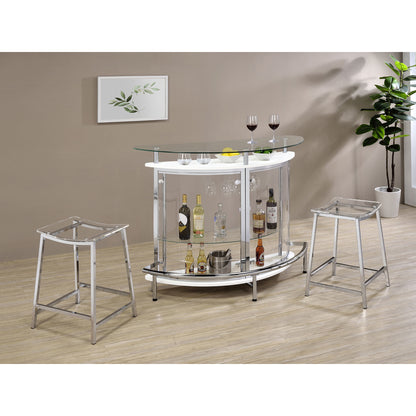 White freestanding home wine bar cabinet with glass top shown in a modern dining room setup with matching bar stools and decor.