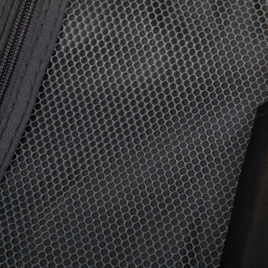 Close-up of black textured ABS spinner luggage material with hexagonal pattern, durable travel bag fabric for suitcase exterior