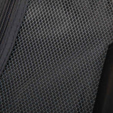 Close-up of black textured ABS spinner luggage material with hexagonal pattern, durable travel bag fabric for suitcase exterior
