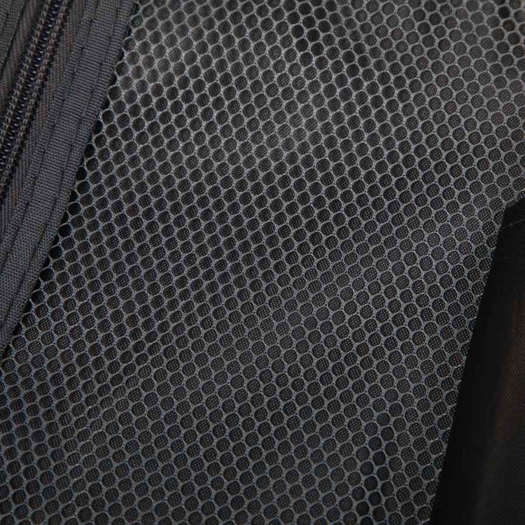 Close-up of black textured ABS spinner luggage material with hexagonal pattern, durable travel bag fabric for suitcase exterior