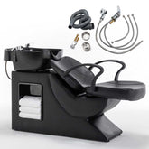 Barber shampoo station with black chair and accessories