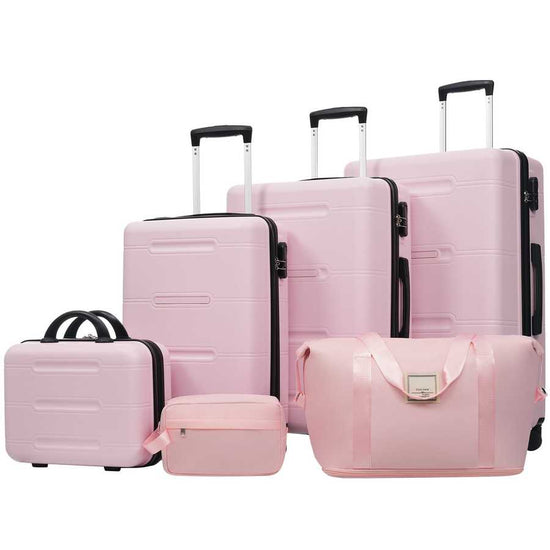Set of pink luggage including suitcases and a handbag on a white background