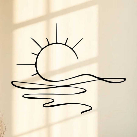 Minimalist sunrise wall art with metal sun and water design