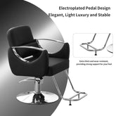 Black salon chair with chrome base and footrest on a gray background